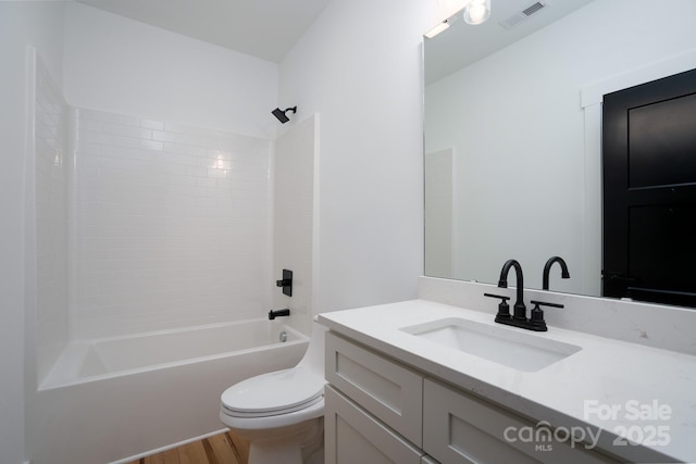 full bathroom featuring vanity, hardwood / wood-style floors, toilet, and shower / bath combination