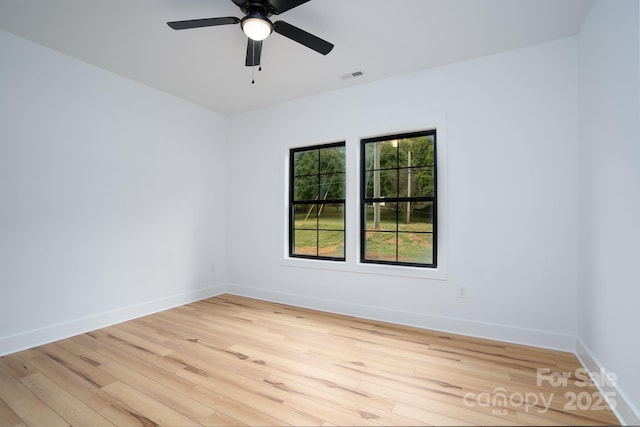 spare room with ceiling fan and light wood-type flooring