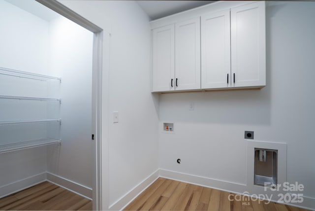 washroom featuring cabinets, hookup for a washing machine, light hardwood / wood-style floors, and electric dryer hookup