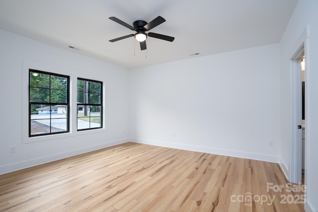 spare room featuring ceiling fan and light wood-type flooring