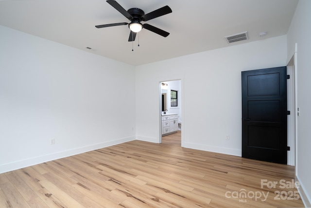 unfurnished bedroom featuring ceiling fan, light hardwood / wood-style floors, and ensuite bath