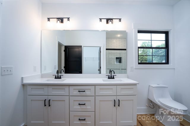 bathroom with walk in shower, vanity, and toilet