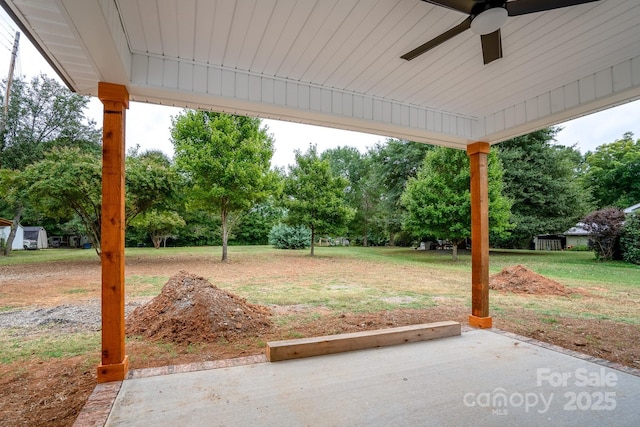 view of yard with a patio area and ceiling fan