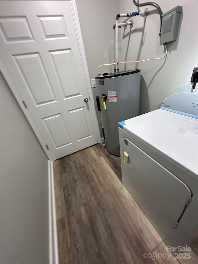 clothes washing area with washer / dryer, dark wood-type flooring, and electric water heater