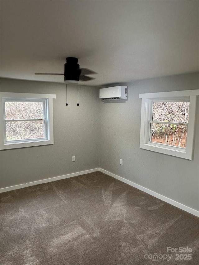 spare room with carpet floors, an AC wall unit, and ceiling fan