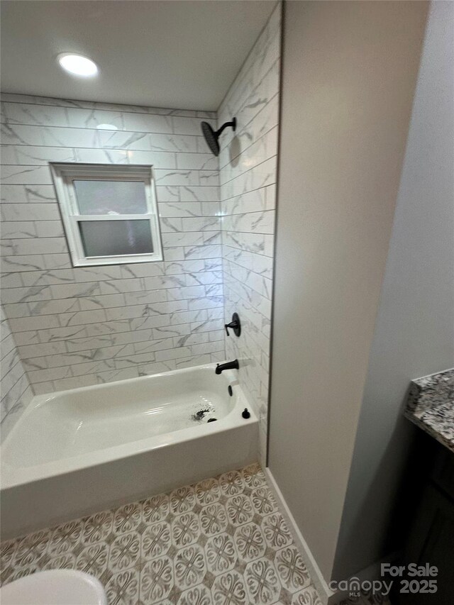 bathroom with tiled shower / bath combo and tile patterned floors