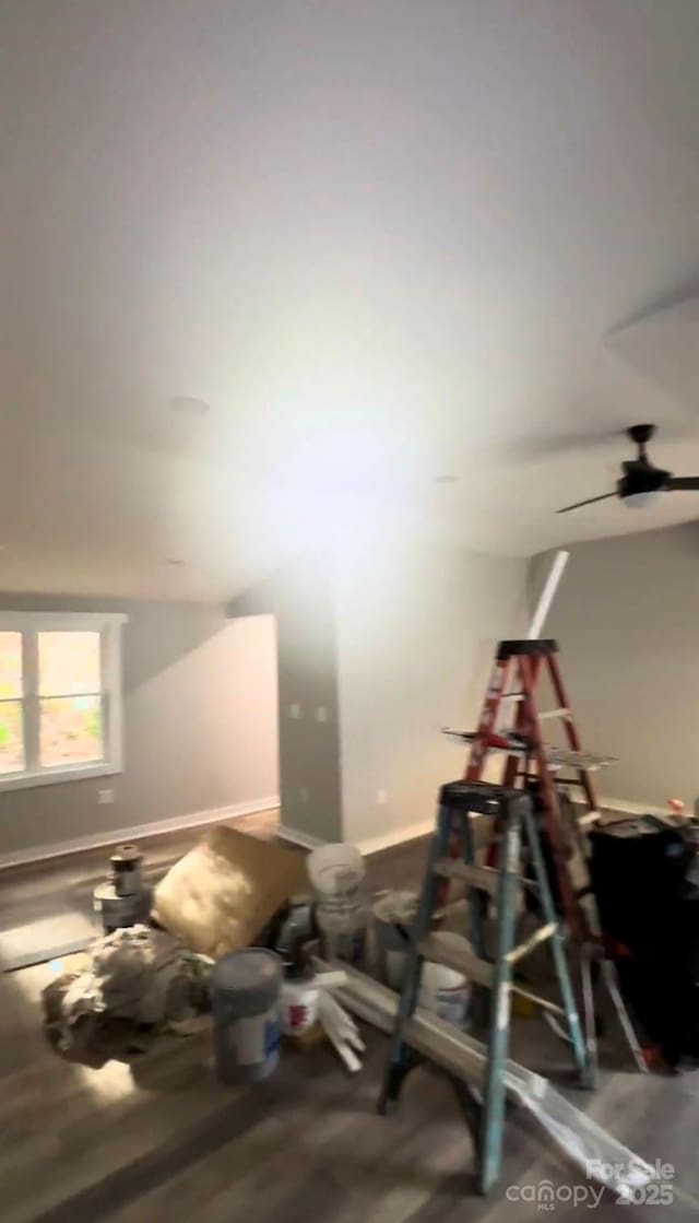 interior space with wood-type flooring and ceiling fan