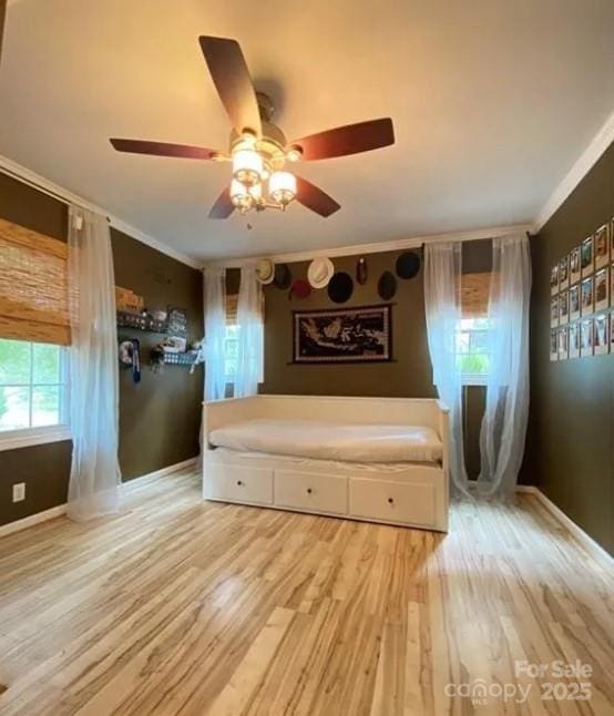 unfurnished bedroom featuring hardwood / wood-style floors, crown molding, and ceiling fan