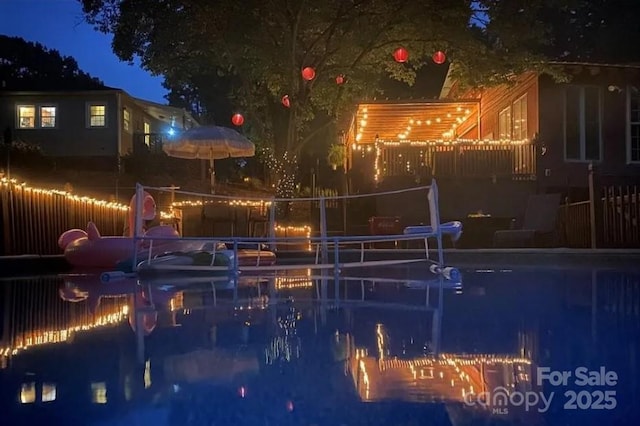 pool at night with volleyball court