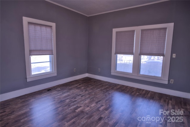 empty room with crown molding and dark hardwood / wood-style floors