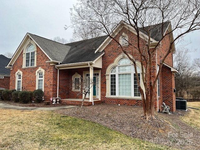 view of property with central AC unit and a front yard