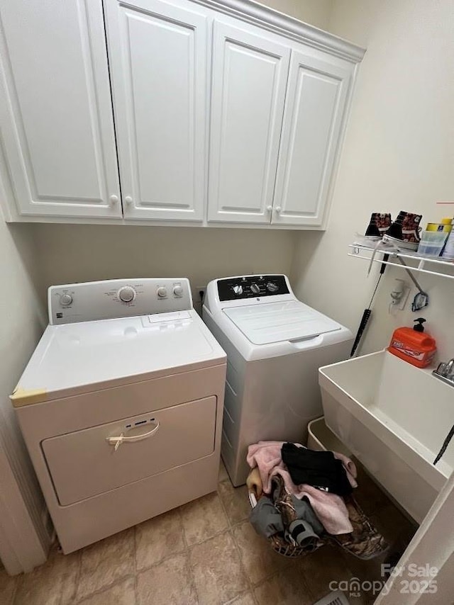 laundry room with sink, independent washer and dryer, and cabinets