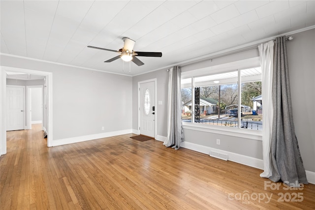 interior space with crown molding, hardwood / wood-style floors, and ceiling fan