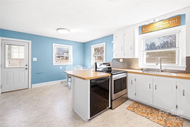 kitchen featuring white cabinetry, dishwasher, sink, stainless steel range with electric cooktop, and decorative backsplash