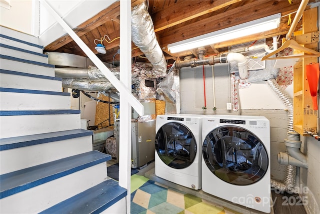 clothes washing area with independent washer and dryer