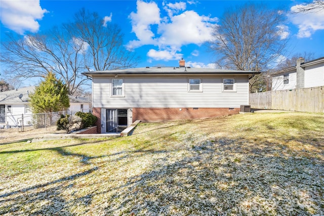 rear view of property featuring a yard