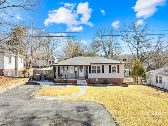 view of front facade with a front yard and covered porch