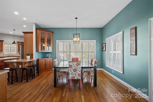 dining room featuring dark hardwood / wood-style floors and a chandelier