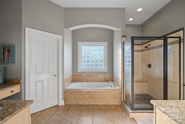 bathroom featuring tile patterned flooring, separate shower and tub, and vanity