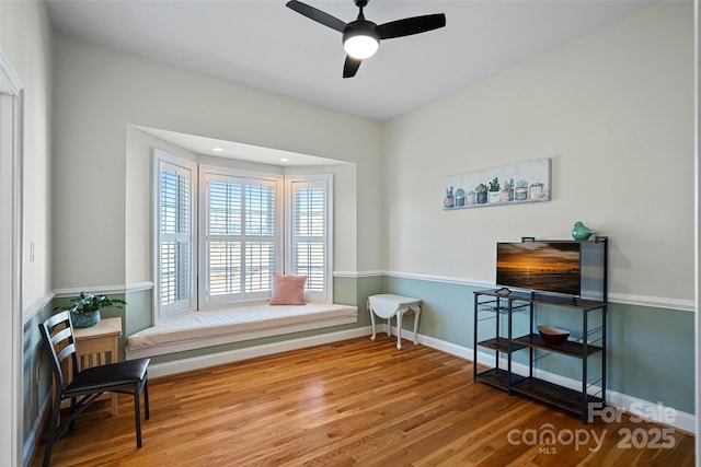 living area with ceiling fan and wood-type flooring