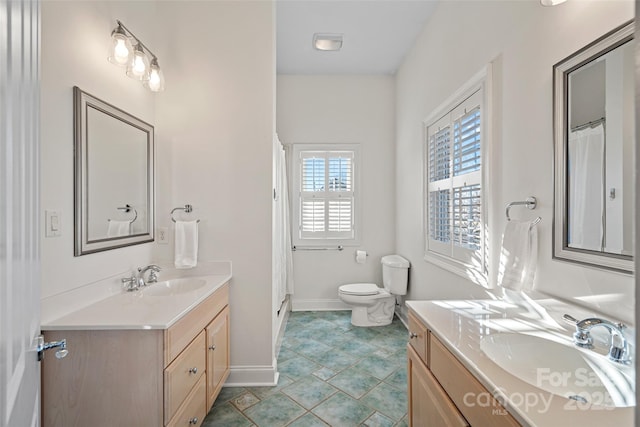 bathroom with toilet, vanity, and tile patterned flooring