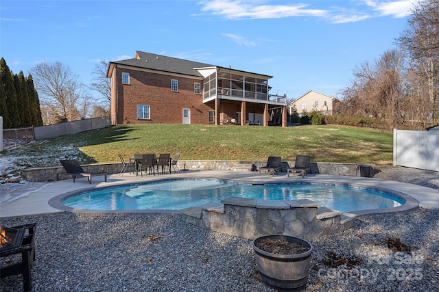 view of swimming pool with a lawn, a patio area, and a sunroom