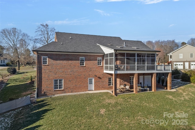 rear view of property featuring a patio area, a sunroom, and a yard