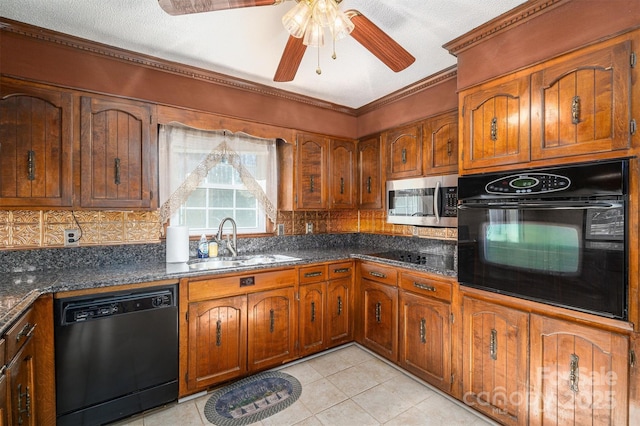 kitchen featuring sink, black appliances, dark stone counters, and light tile patterned floors