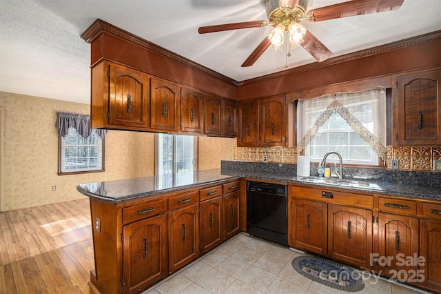 kitchen featuring a textured ceiling, dishwasher, sink, kitchen peninsula, and ceiling fan