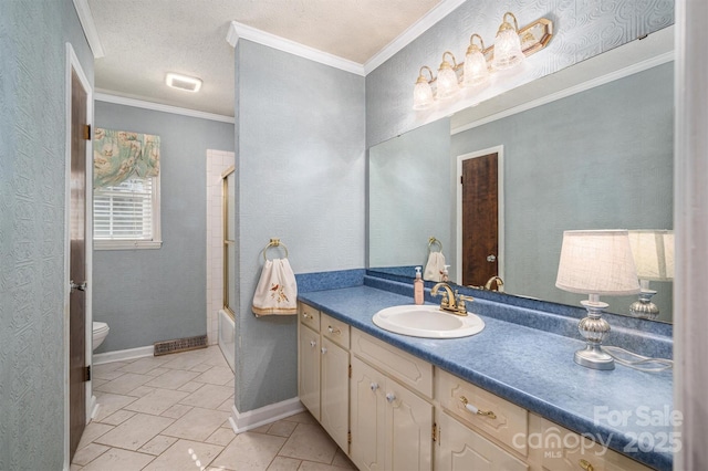 full bathroom featuring toilet, enclosed tub / shower combo, a textured ceiling, ornamental molding, and vanity