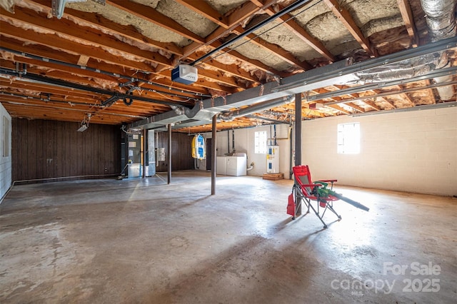 basement with washing machine and dryer and electric water heater