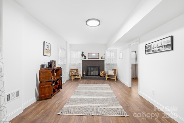 sitting room featuring wood-type flooring and a fireplace