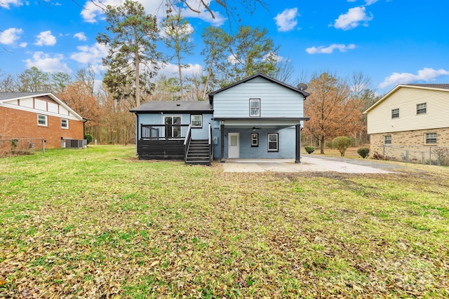 view of front of property featuring a patio area, a front yard, and central air condition unit