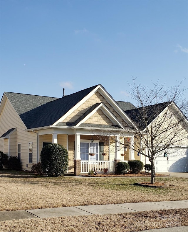 view of front of property with a porch and a front yard