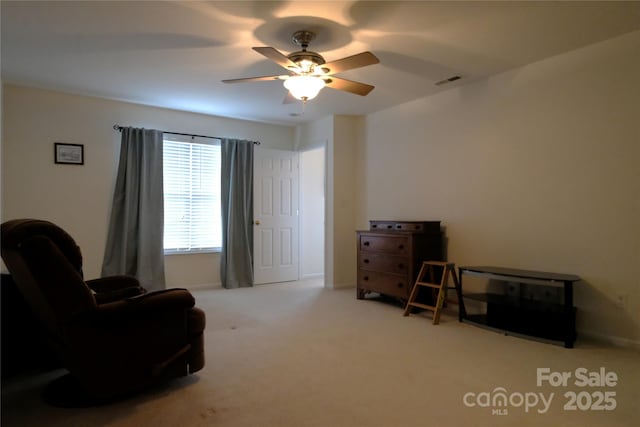 sitting room featuring ceiling fan and light colored carpet