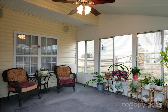 sunroom with ceiling fan and beam ceiling