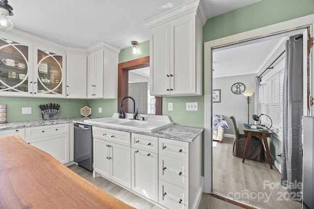 kitchen featuring sink, white cabinetry, and light hardwood / wood-style flooring