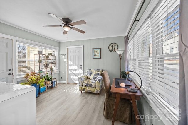 living area featuring ceiling fan, ornamental molding, and light hardwood / wood-style floors