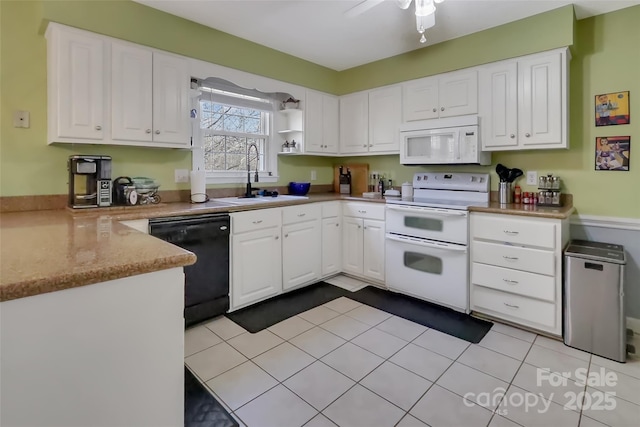 kitchen with sink, light tile patterned floors, white cabinets, and white appliances