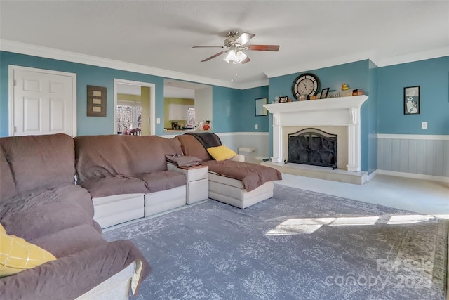 carpeted living room featuring crown molding and ceiling fan