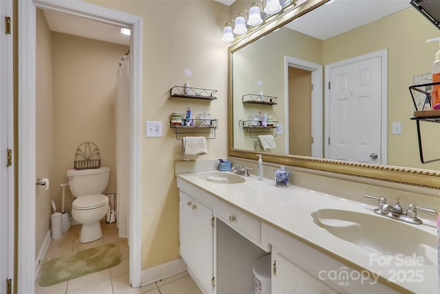 bathroom featuring vanity, tile patterned floors, and toilet