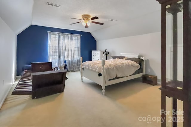 carpeted bedroom featuring ceiling fan and vaulted ceiling