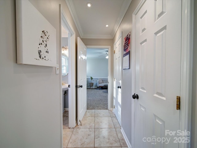 hallway featuring light colored carpet and ornamental molding