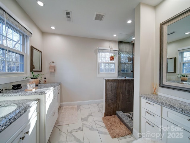 bathroom with a shower and vanity