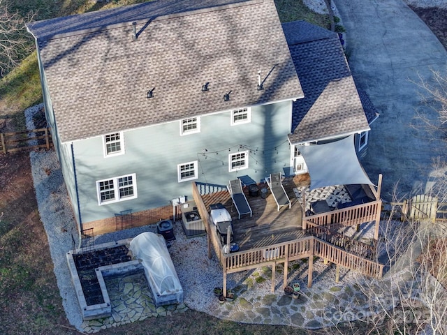 rear view of house with a deck and a playground