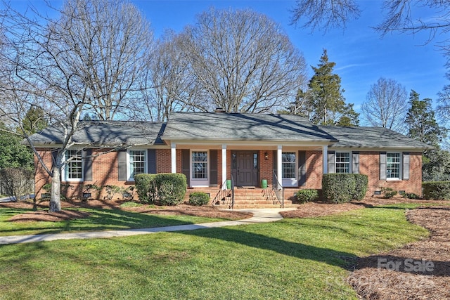 ranch-style house with covered porch and a front yard