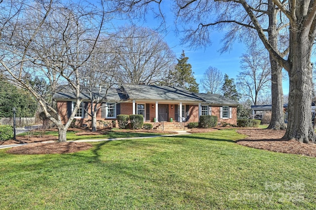 ranch-style house featuring a porch and a front yard