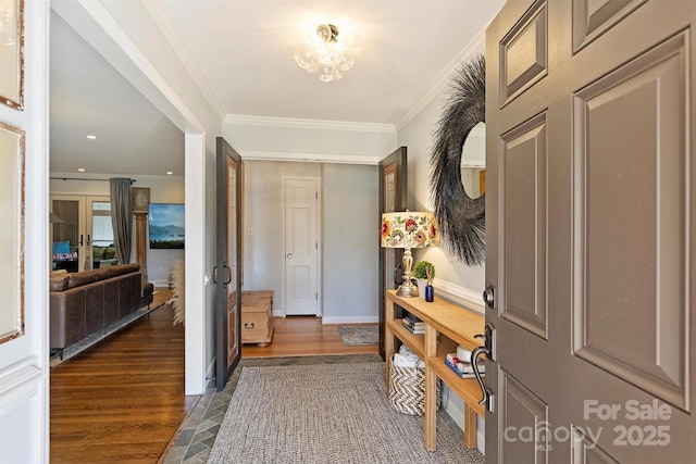 entrance foyer with an inviting chandelier and ornamental molding