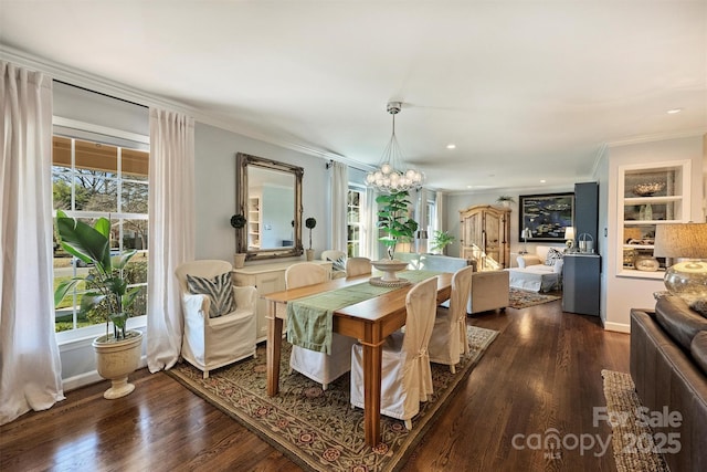 dining area with plenty of natural light, dark hardwood / wood-style flooring, and a chandelier