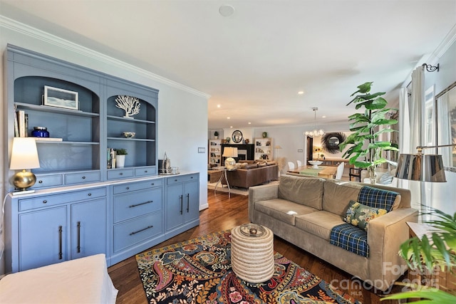 living room featuring dark wood-type flooring, an inviting chandelier, and ornamental molding